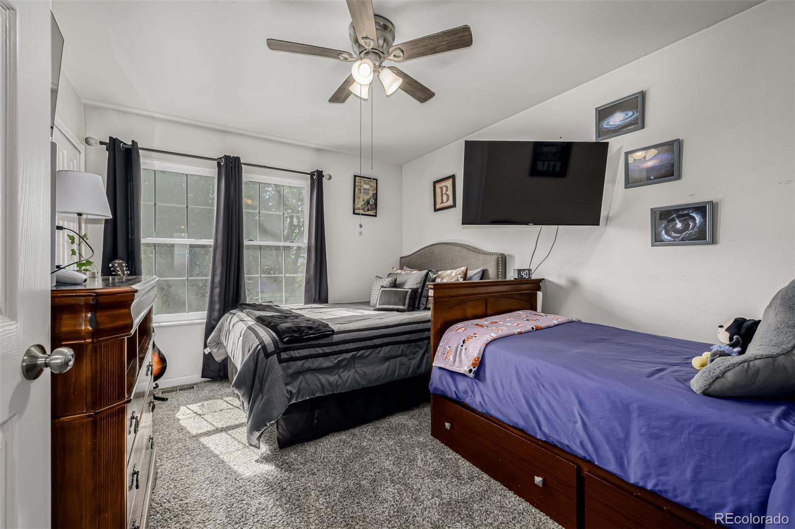 4282 Charleston Drive Colorado Springs, CO 80916 - Photo 16 of 50 a bedroom with a bed and a chandelier