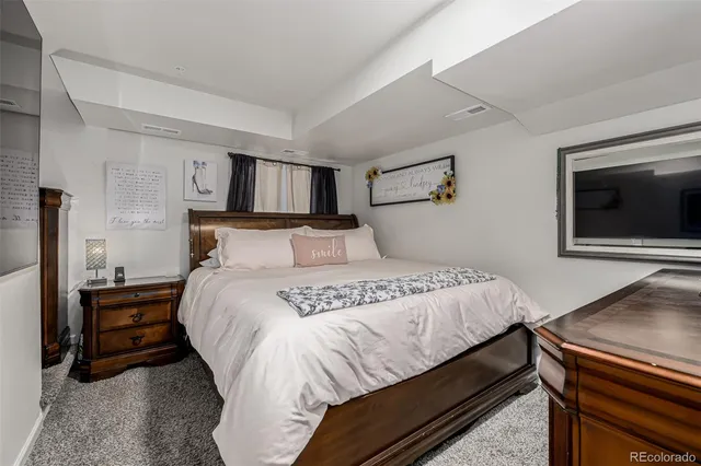 a bedroom with a bed and a tv