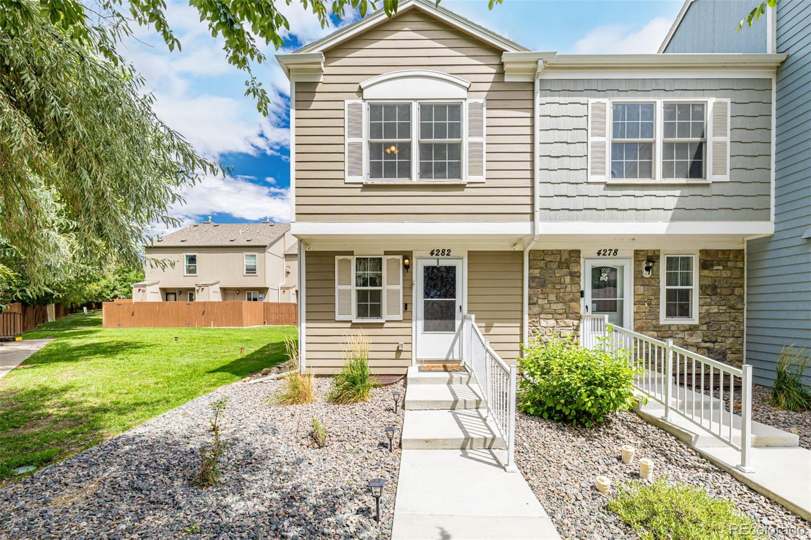 4282 Charleston Drive Colorado Springs, CO 80916 - Photo 2 of 50 a front view of a house with garden