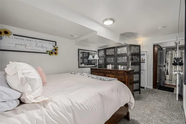 a bedroom with a large bed and a dresser