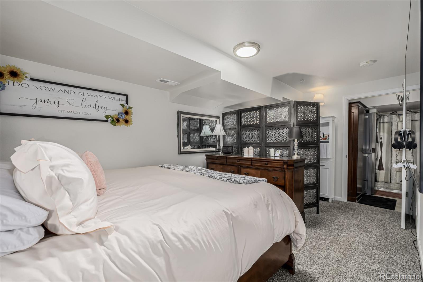 4282 Charleston Drive Colorado Springs, CO 80916 - Photo 21 of 50 a bedroom with a large bed and a dresser