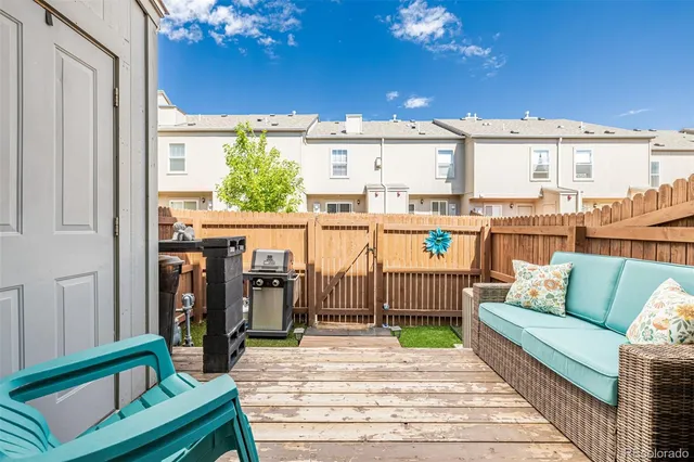a view of a balcony with furniture and a potted plant