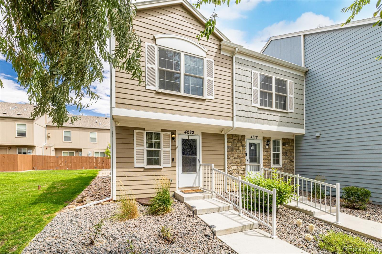 4282 Charleston Drive Colorado Springs, CO 80916 - Photo 3 of 50 a front view of a house with a yard