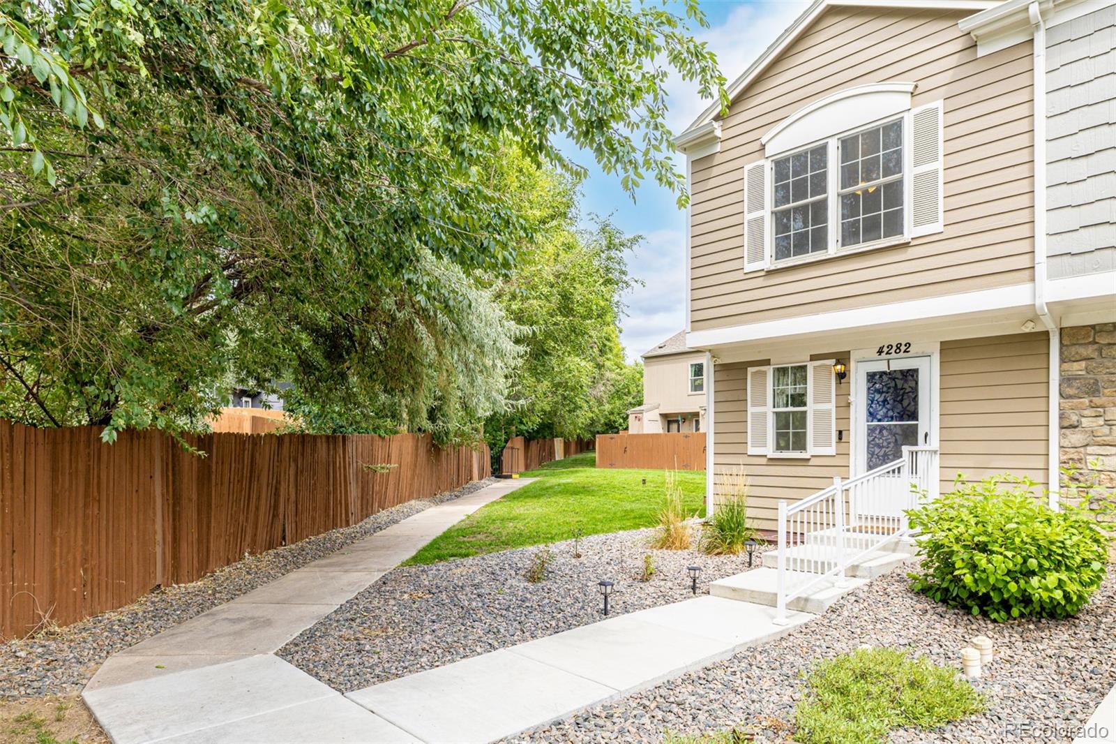 4282 Charleston Drive Colorado Springs, CO 80916 - Photo 4 of 50 front view of a house with a yard and an trees