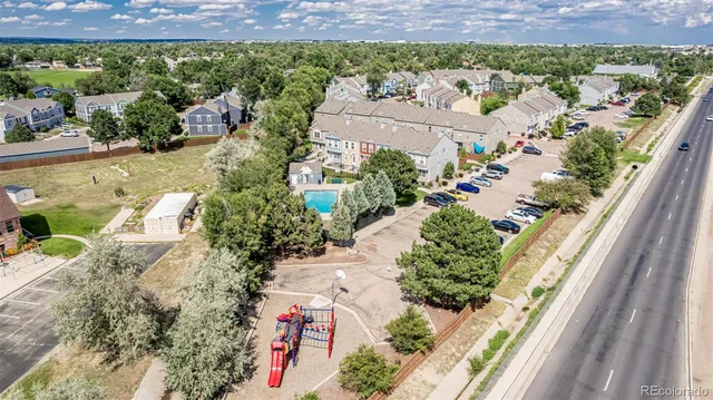 an aerial view of a house with a yard and lake view