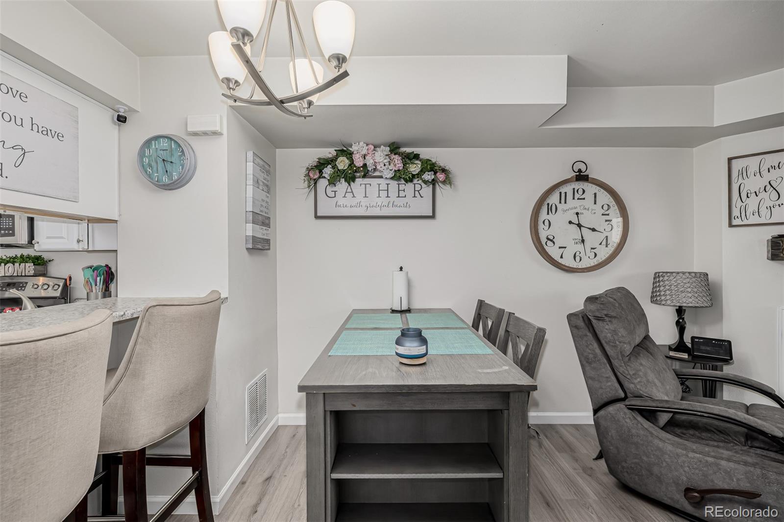 4282 Charleston Drive Colorado Springs, CO 80916 - Photo 7 of 50 a view of a dining area with furniture and a clock