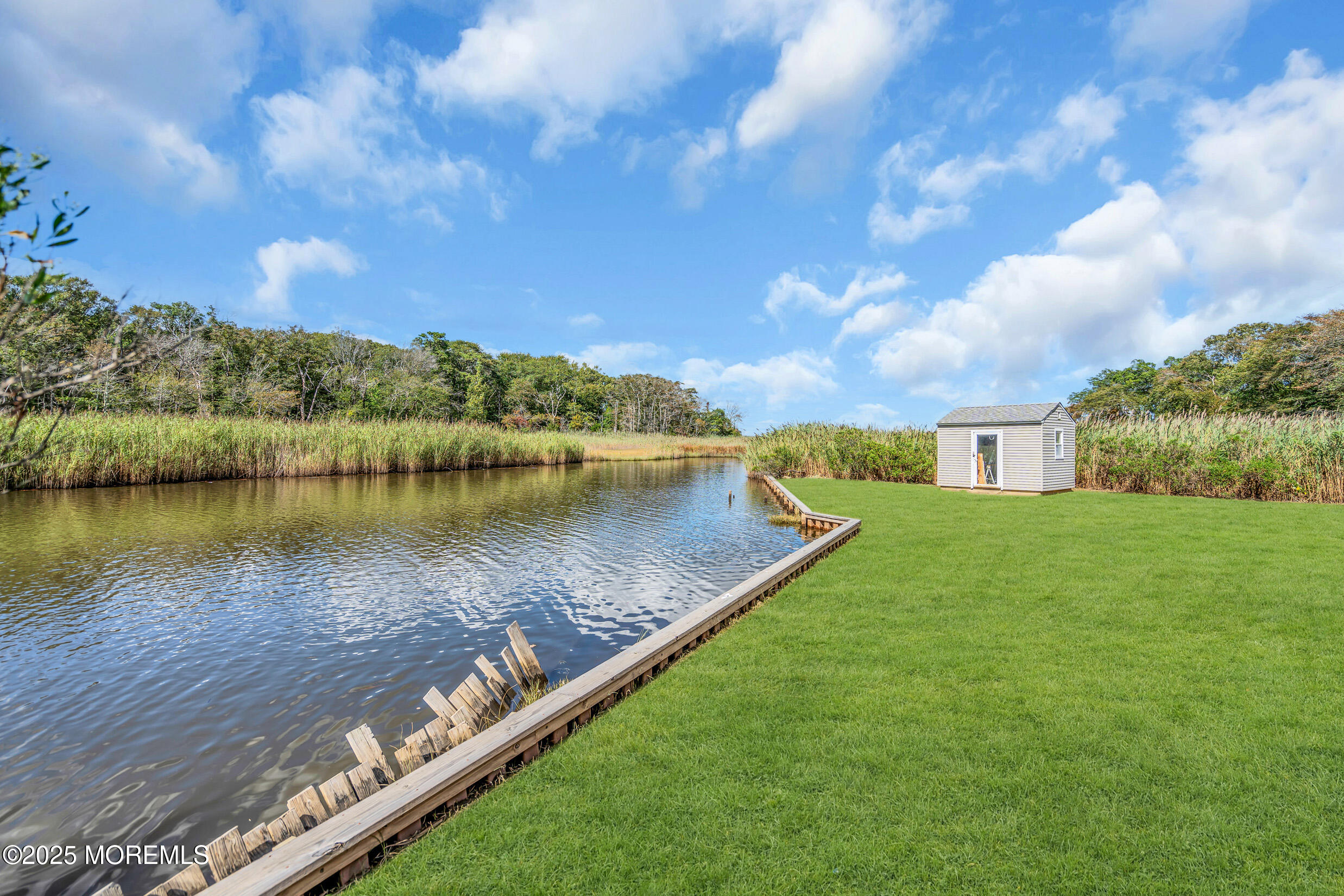 615 Riverside Drive Bayville, NJ 08721 - Photo 19 of 25 a view of a lake with a yard