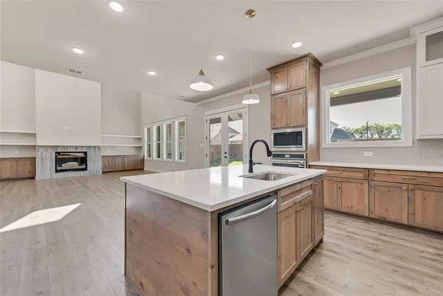 a kitchen with a sink stove and cabinets