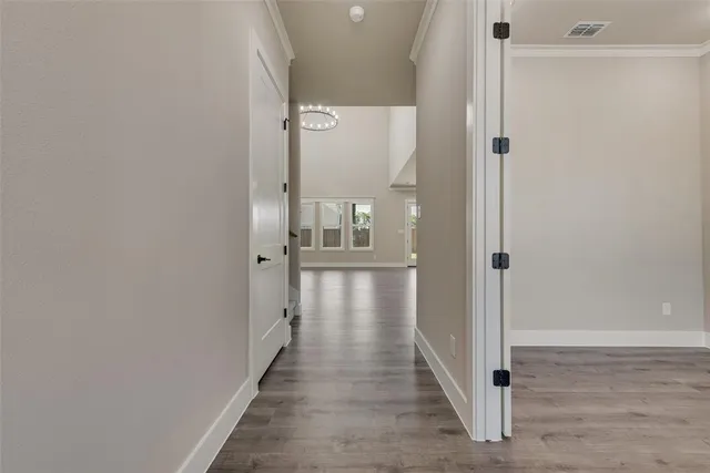 a view of a hallway with wooden floor