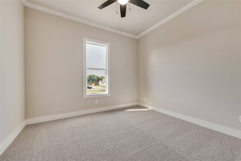 1323 Selby Road Van Alstyne, TX 75495 - Photo 29 of 38 an empty room with chandelier fan and windows