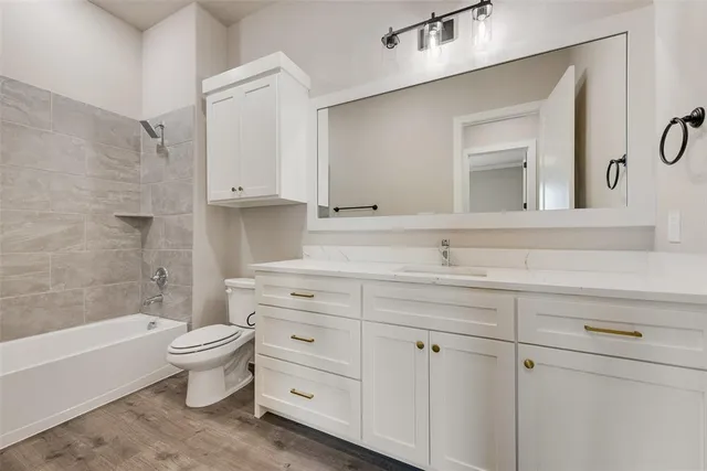 a bathroom with a sink a toilet and bathtub