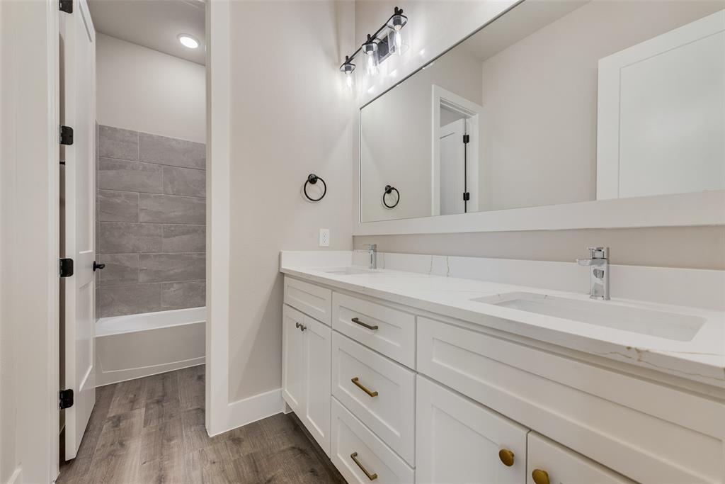 1323 Selby Road Van Alstyne, TX 75495 - Photo 32 of 38 a bathroom with a bathtub and a sink