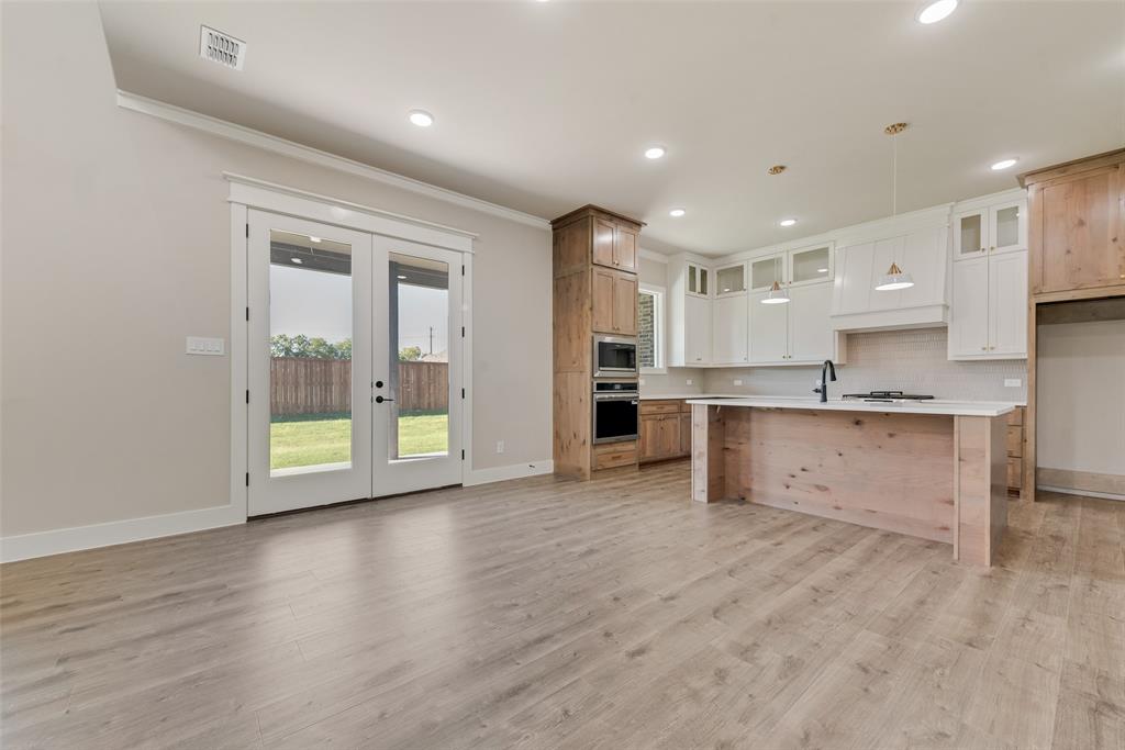 1323 Selby Road Van Alstyne, TX 75495 - Photo 6 of 38 a view of kitchen with kitchen island wooden cabinets and refrigerator