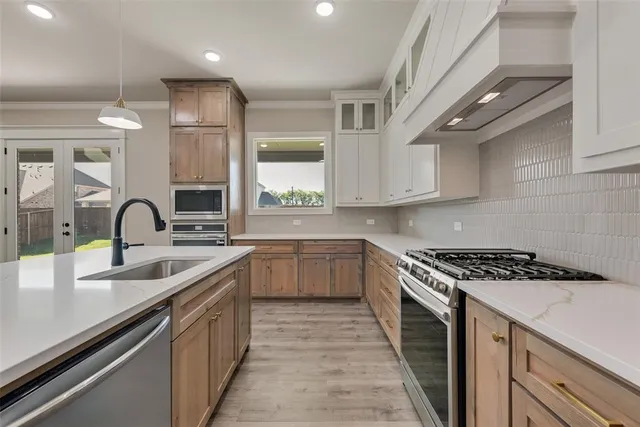 a kitchen with stainless steel appliances granite countertop a sink and cabinets