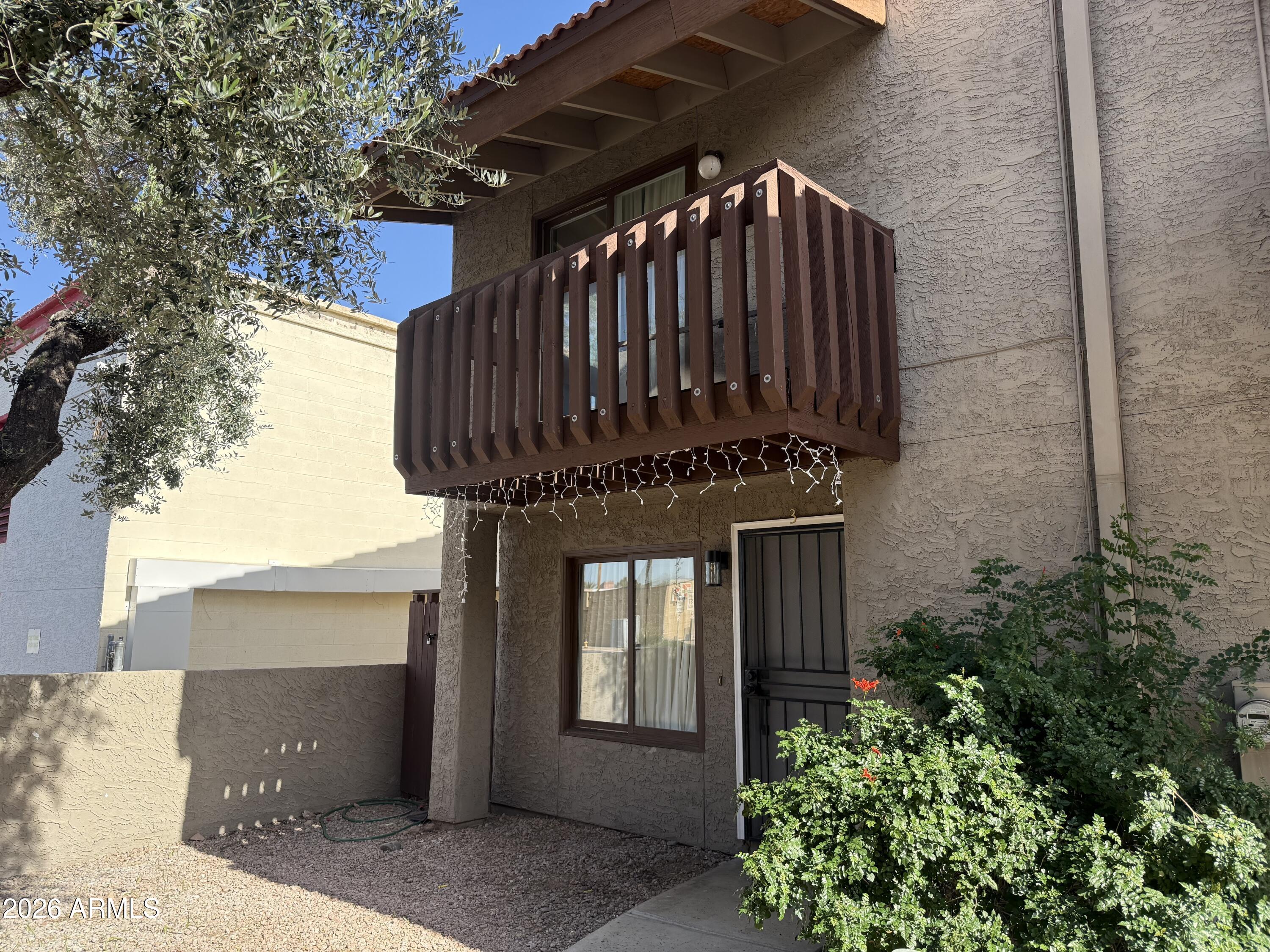 2815 North 52nd Street, Unit 3 Phoenix, AZ 85008 - Photo 7 of 7 a view of a house with a door and a flower plants