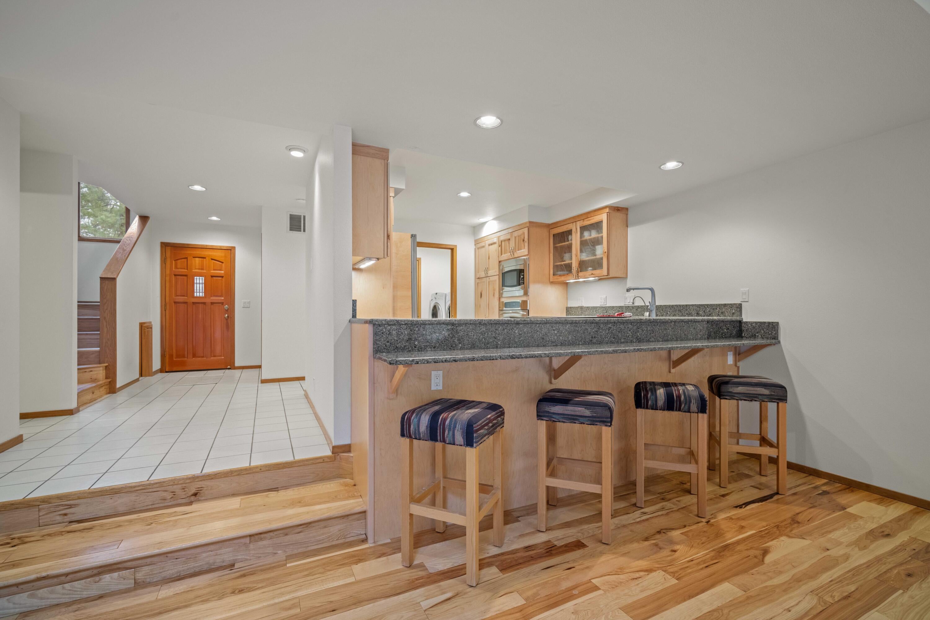 17674 Bittern Lane, Unit 7 Sunriver, OR 97707 - Photo 10 of 43 Open-concept layout connects, living, dining, kitchen, and entry spaces.