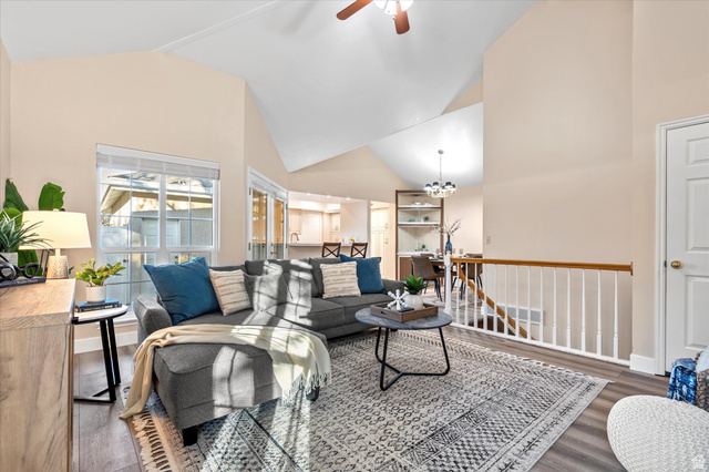 888 East 6895 South Midvale, UT 84047 - Photo 4 of 54 Bright, open living area with vaulted ceilings and large windows that fill the space with natural light, creating an inviting atmosphere for relaxing or entertaining.