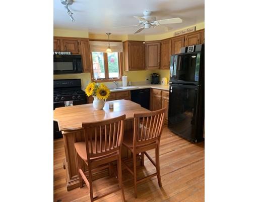 130 Pilgrim Road Weymouth, MA 02191 - Photo 5 of 14 a kitchen with a table chairs refrigerator and microwave