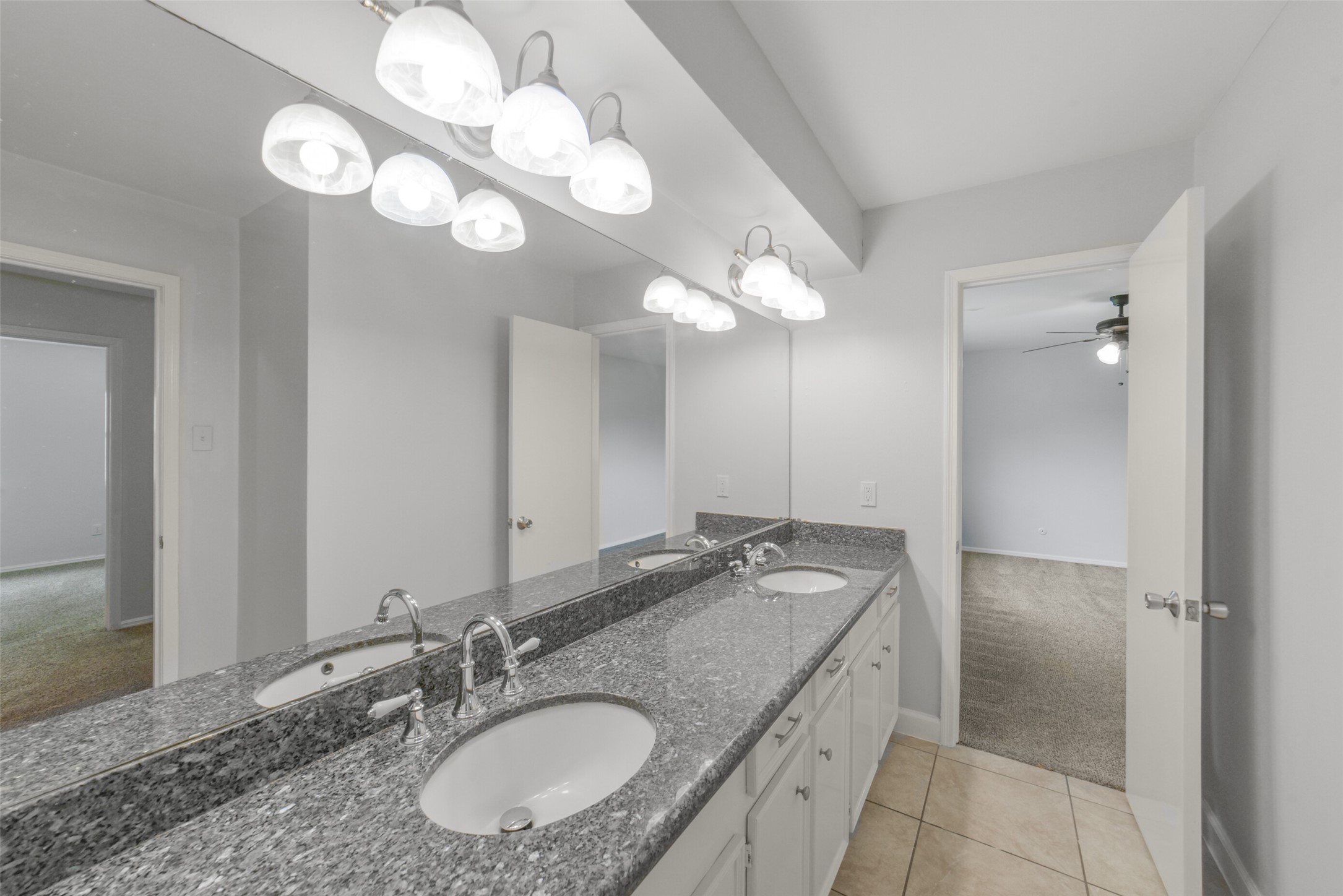 7611 Theisswood Road Spring, TX 77379 - Photo 27 of 41 Secondary upstairs bathroom features a long dual-sink vanity.