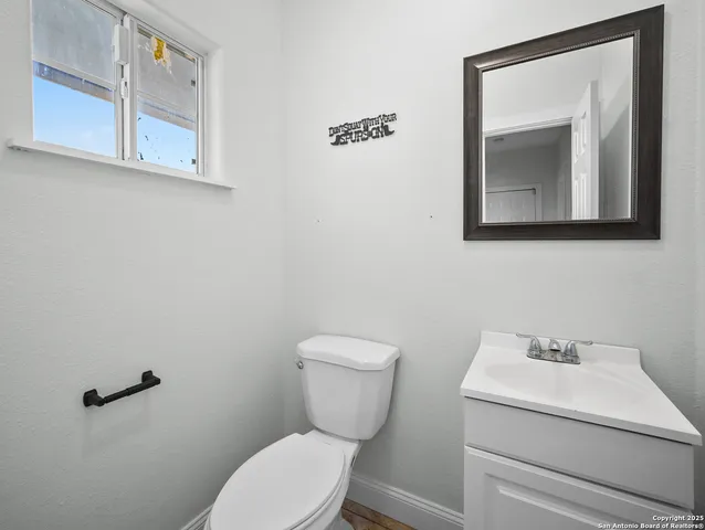 a bathroom with a toilet sink and mirror