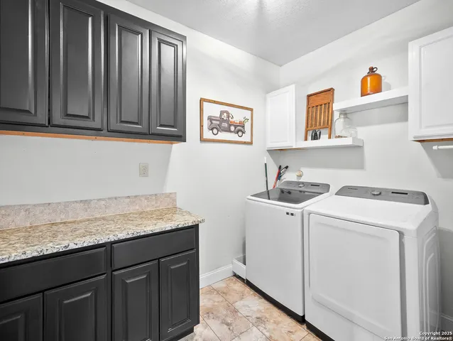 a utility room with sink dryer and washer