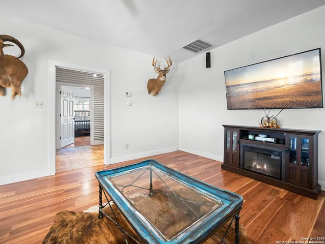 a living room with pool table and a flat screen tv