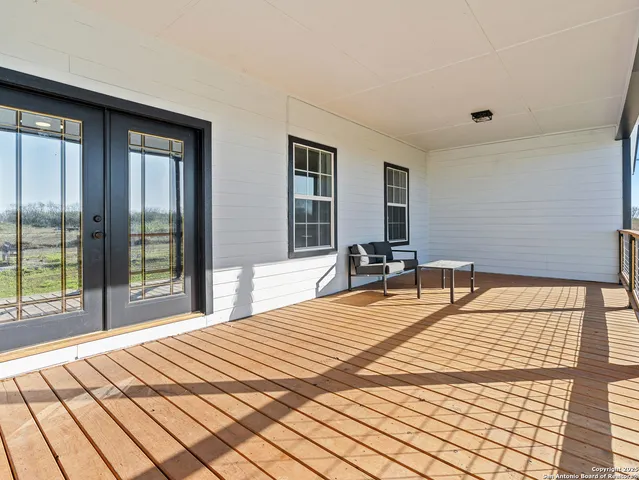 a bedroom with a large bed and a large window