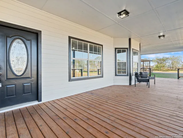 a bedroom with a bed and a dresser next to a window