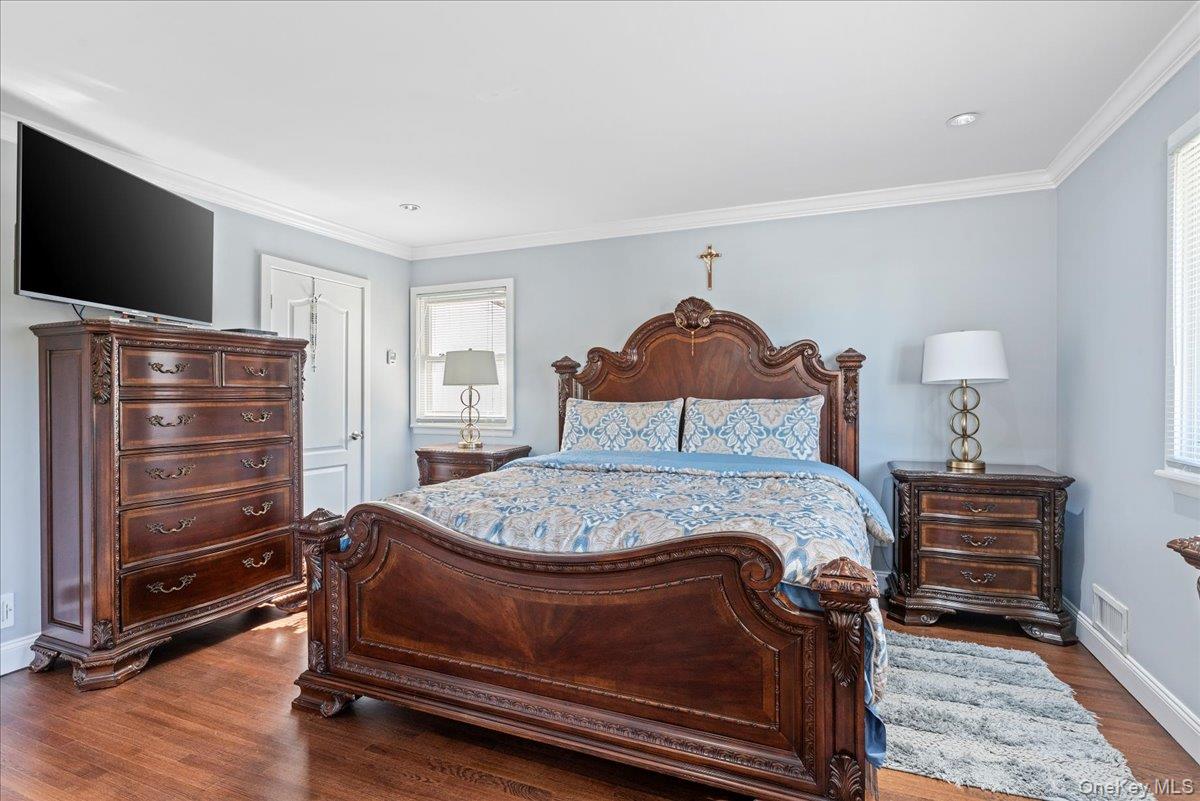 269 Hungry Harbor Road Valley Stream, NY 11581 - Photo 13 of 34 a bedroom with a bed and a flat screen tv