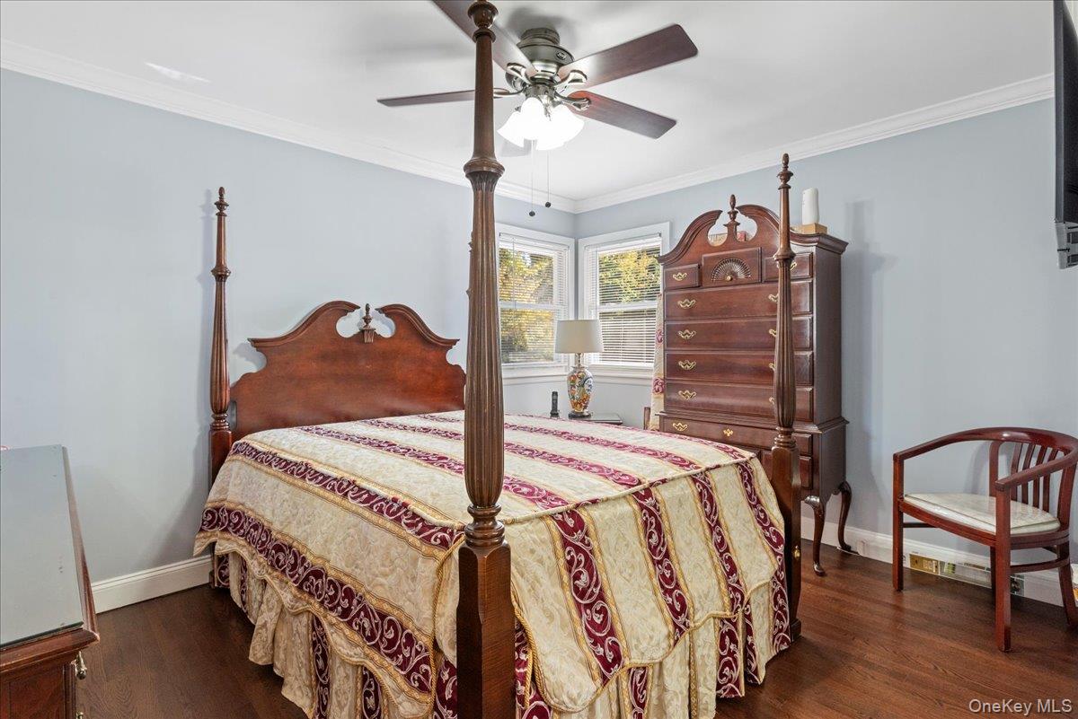 269 Hungry Harbor Road Valley Stream, NY 11581 - Photo 18 of 34 a bedroom with a bed a dresser and wooden floor