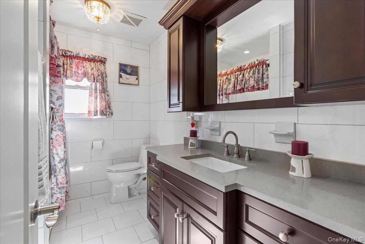269 Hungry Harbor Road Valley Stream, NY 11581 - Photo 19 of 34 a bathroom with a sink and a toilet