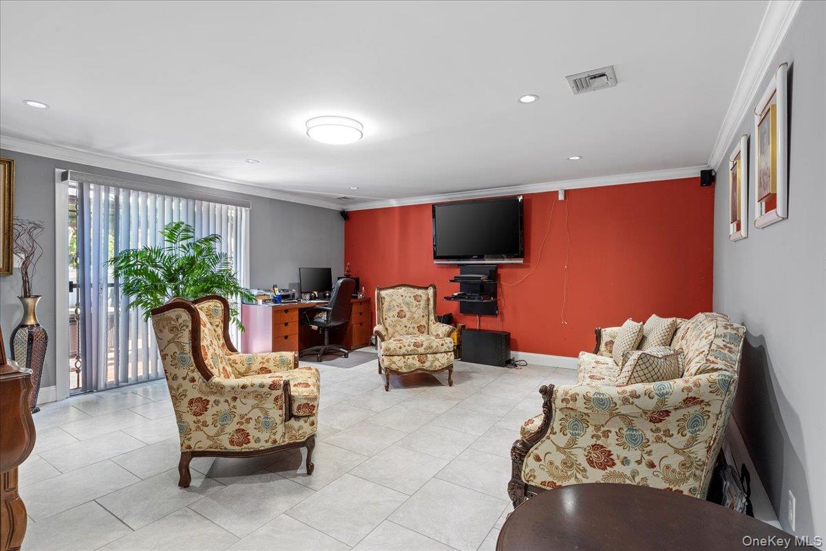 269 Hungry Harbor Road Valley Stream, NY 11581 - Photo 20 of 34 a outdoor living space with furniture and a flat screen tv