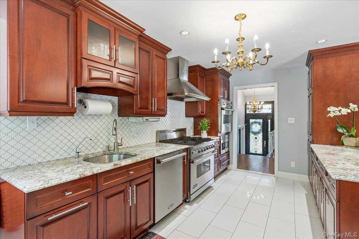 269 Hungry Harbor Road Valley Stream, NY 11581 - Photo 2 of 34 a kitchen with a sink stove and refrigerator