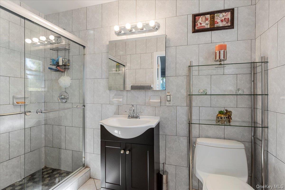 269 Hungry Harbor Road Valley Stream, NY 11581 - Photo 22 of 34 a bathroom with a sink toilet and shower