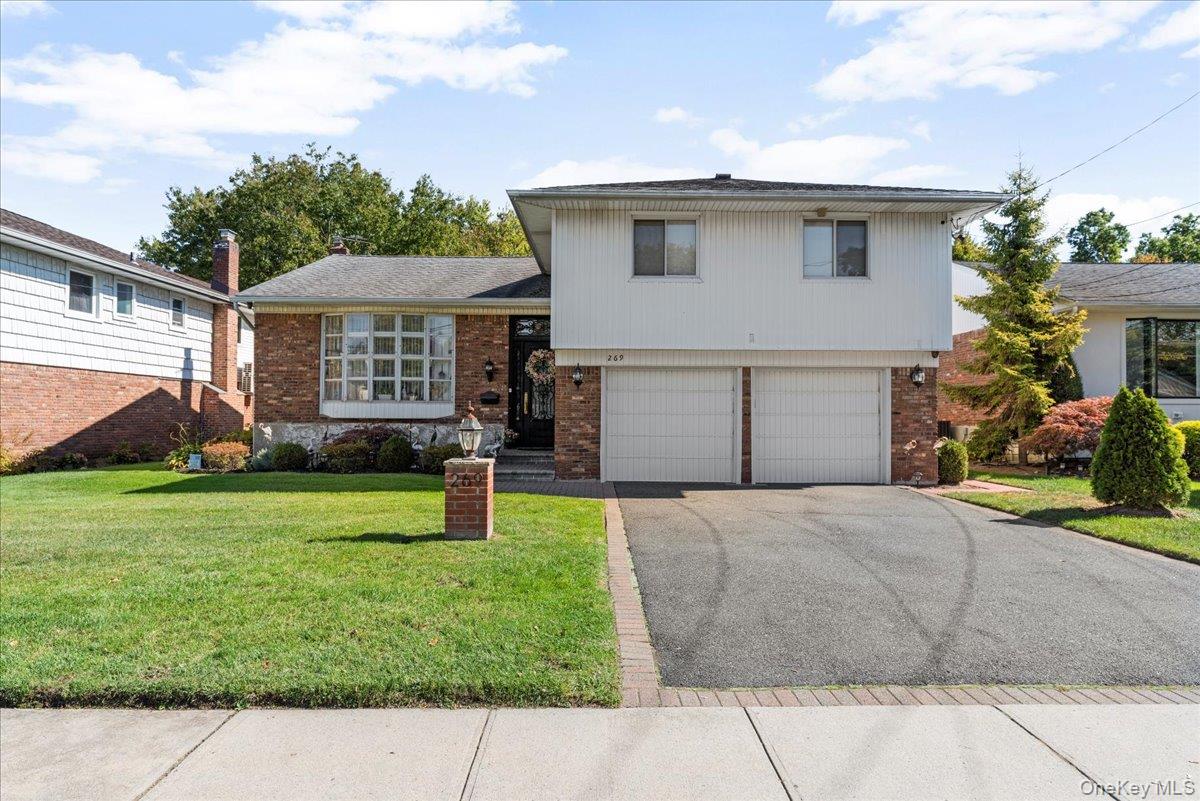 269 Hungry Harbor Road Valley Stream, NY 11581 - Photo 31 of 34 a front view of a house with garden