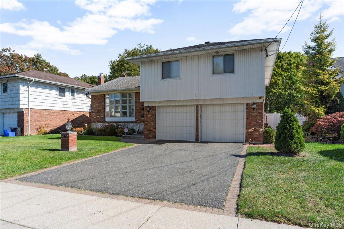 269 Hungry Harbor Road Valley Stream, NY 11581 - Photo 32 of 34 a front view of house with yard and green space