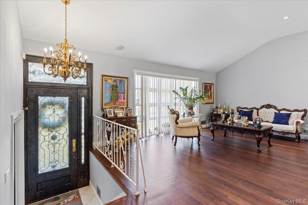 269 Hungry Harbor Road Valley Stream, NY 11581 - Photo 6 of 34 a living room with furniture and a chandelier