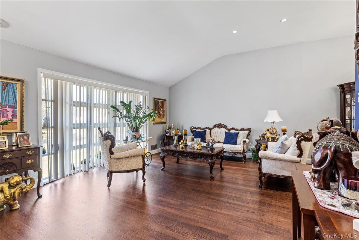 269 Hungry Harbor Road Valley Stream, NY 11581 - Photo 7 of 34 a living room with fireplace furniture and a wooden floor