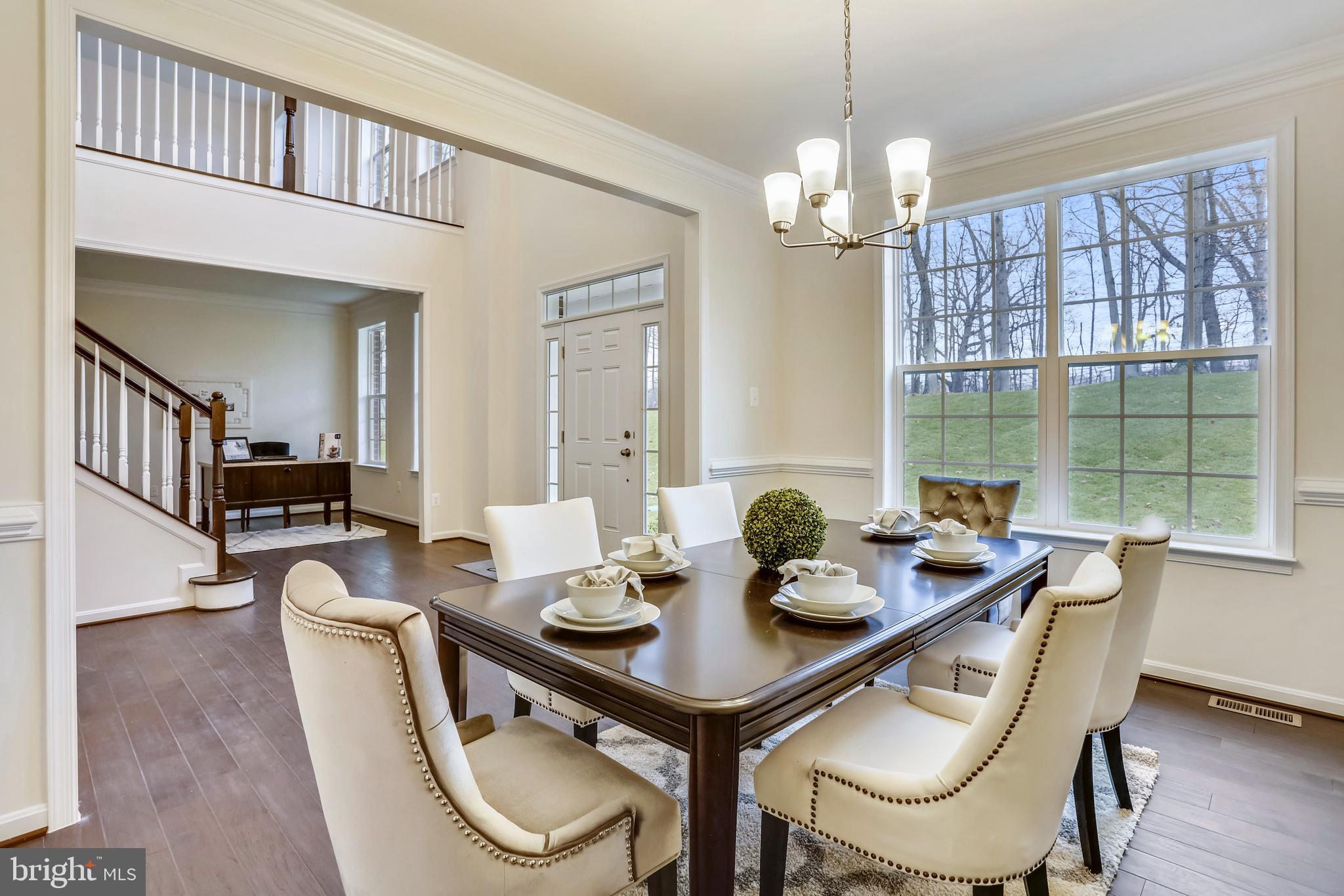 3916 Diplomat Avenue Bowie, MD 20721 - Photo 3 of 18 a view of a dining room with furniture a chandelier and wooden floor