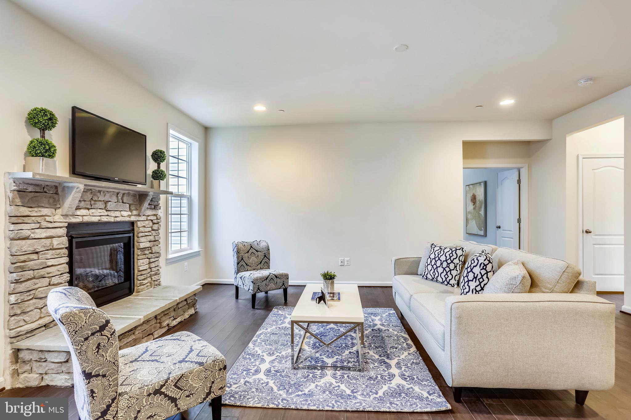 3916 Diplomat Avenue Bowie, MD 20721 - Photo 6 of 18 a living room with furniture a fireplace and a flat screen tv