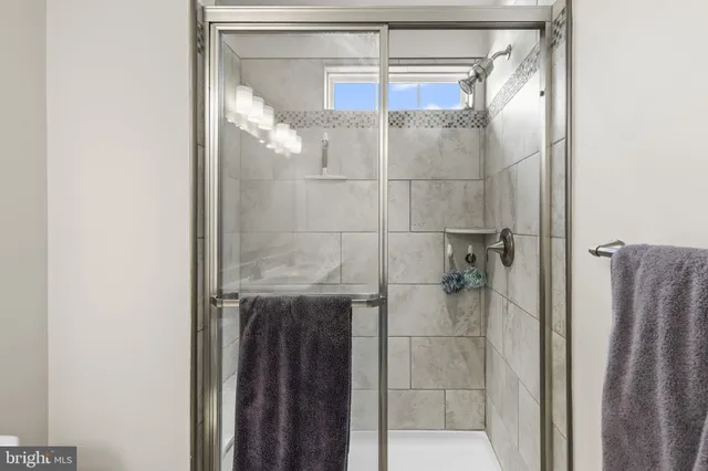 a bathroom with a glass shower door