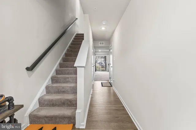 a view of entryway and hall with wooden floor