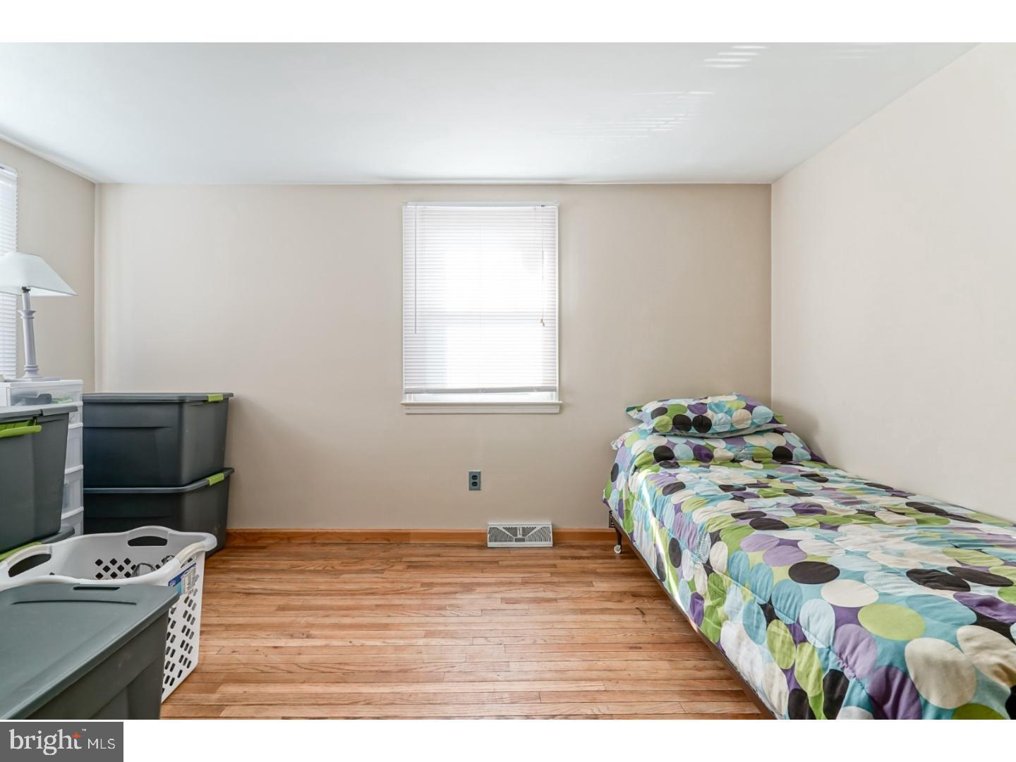 9 Deptford Road Glassboro, NJ 08028 - Photo 15 of 20 a bedroom with a bed and a table in it