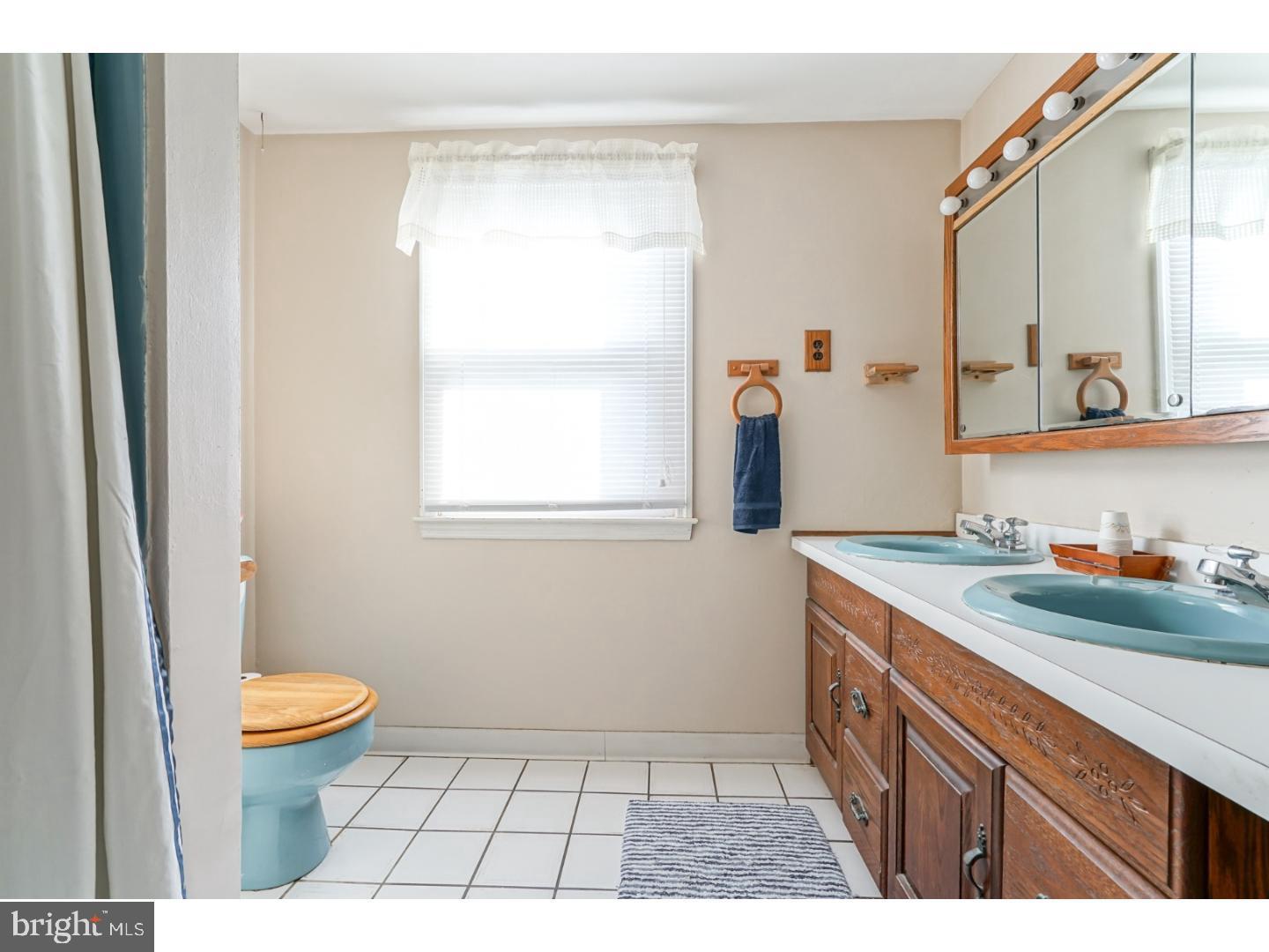 9 Deptford Road Glassboro, NJ 08028 - Photo 17 of 20 a bathroom with a granite countertop sink a toilet a mirror and shower