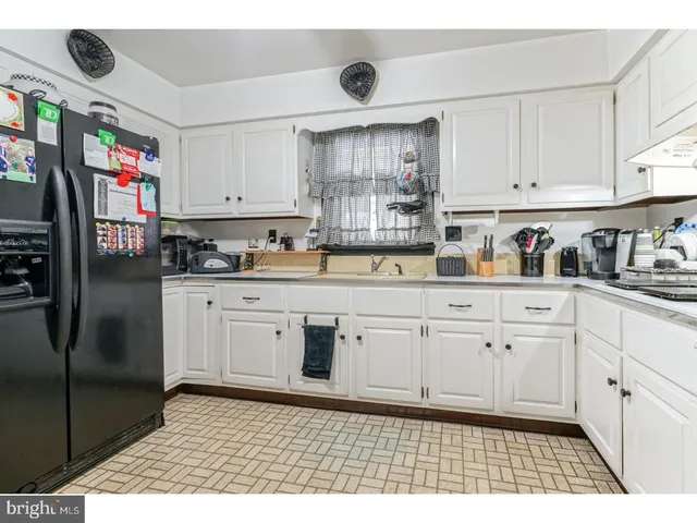 a kitchen with stainless steel appliances granite countertop a sink a stove a refrigerator and cabinets