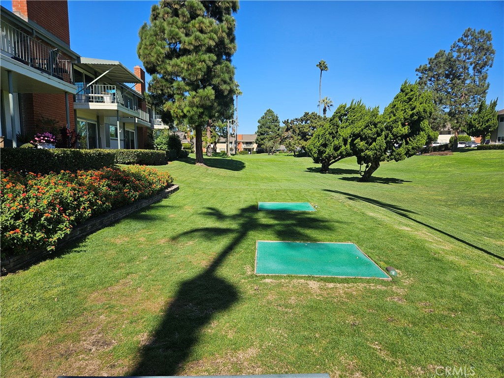 a view of yard with swimming pool and green space