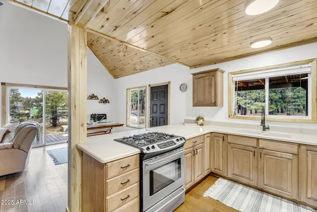 a kitchen with stainless steel appliances granite countertop a stove a refrigerator and a dining table