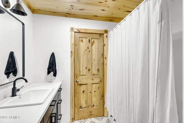 a bathroom with a sink a mirror and shower