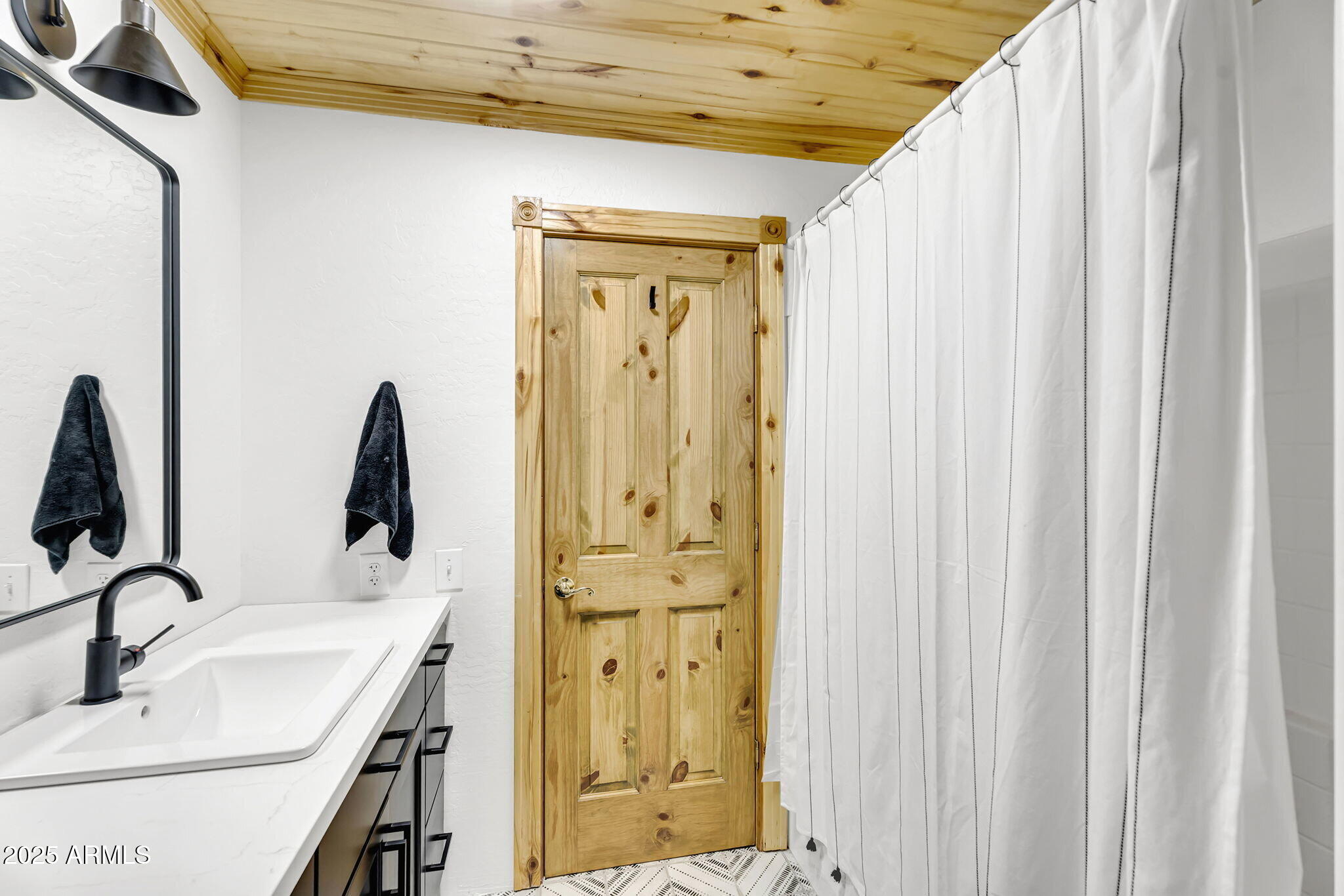 5348 Forest Service 701 Road Happy Jack, AZ 86024 - Photo 22 of 59 a bathroom with a sink a mirror and shower