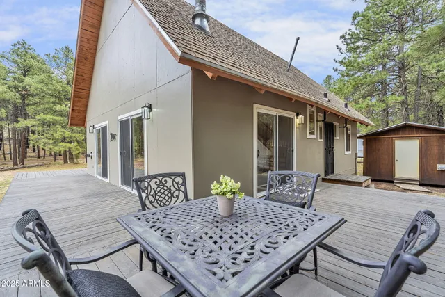 a view of a dinning table and chairs in patio of the house